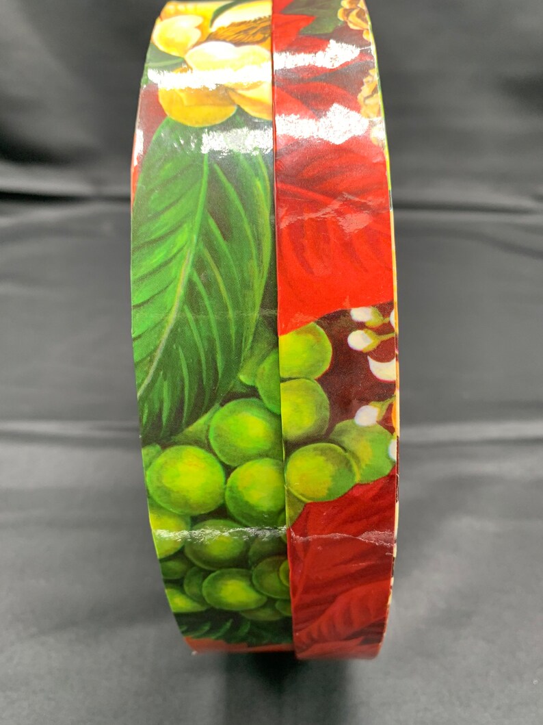 A Round Decorative Cardboard Storage Box Covered in Primarily Christmas