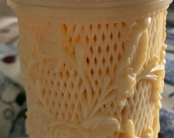 A vintage set of cocktail forks in a decorative container.