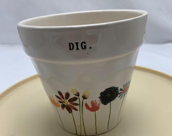 An indoor or outdoor ceramic planter by Rae Dunn.