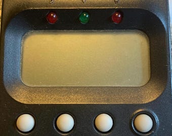 May include: A black KORG GA-10 guitar and bass tuner with a digital display, red and green indicator lights, and buttons for auto guitar/bass, manual string, flat, and power.