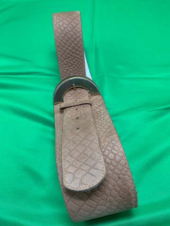 A light tan, suede belt by Christian Dior.