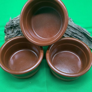 A trio of Cermer ramekins in a terra cotta.