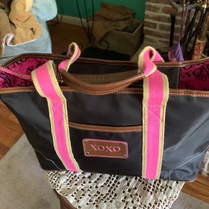 Vintage XOXO brand handbag in black nylon with hot pink handles.