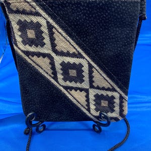 A soft flannel, Aztec like designed crossbody in brown.