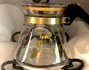 A small, mid-century Pyrex, glass coffee/tea pot in gold clover.