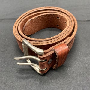 A men’s leather, double prong belt by Levi’s.