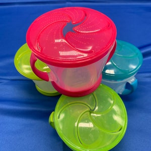 A set of four Munchkins with lids for snacking.