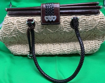 A Brighton straw handbag with leather trim.
