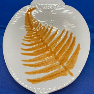 A platter with a gold fern, from a Mottahedeh, hand painted from Portugal.