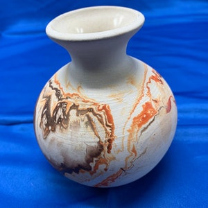 Nemadji pottery vase in earth tones swirls.