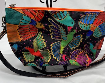 A Laurel Burch shoulder bag in a bird pattern.