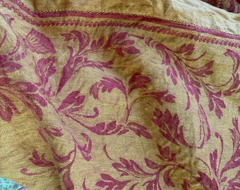 A large gold and auburn coverlet, made in Portugal.