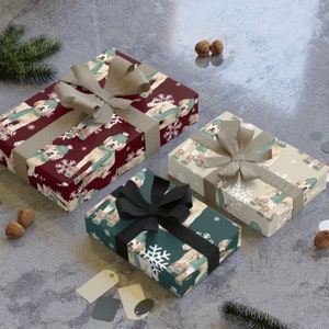 May include: Three gift boxes wrapped in festive holiday paper featuring a dog wearing a winter hat. The boxes are tied with brown, black, and beige ribbon. The paper features a red, green, and beige color scheme with snowflakes and a dog pattern.
