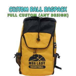May include: Yellow and black backpack with the text "CUSTOM BALL BAGPACK FULL CUSTOM (ANY DESIGN)". The backpack has a drawstring closure and side mesh pockets. The front of the backpack features a basketball graphic and the words "MBA LADY BASKETBALL".