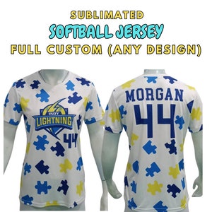 May include: White softball jersey with a blue and yellow puzzle piece pattern. The jersey has the text "Indy Lightning" and the number "44" on the front. The back of the jersey has the name "Morgan" and the number "44".