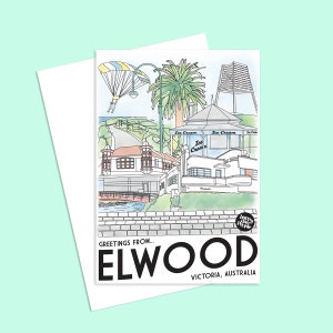 Peut inclure: Une carte postale illustrant une ville côtière appelée Elwood, Victoria, Australie. La carte postale présente une illustration colorée d'une ville balnéaire avec un phare, des palmiers, un pont et un parachute dans le ciel. Le texte "Greetings from... Elwood, Victoria, Australia" est imprimé sur la carte postale.