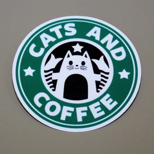 May include: A green and white sticker with the text "Cats and Coffee" and a cartoon cat in the center. The cat is white with black ears, a black nose, and black eyes. The cat is wearing a black collar with a white star.