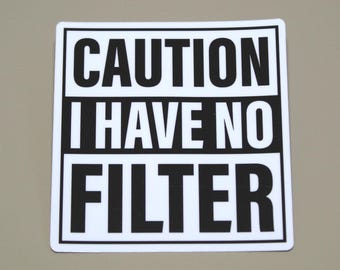 May include: White square sign with black text that reads "CAUTION I HAVE NO FILTER".