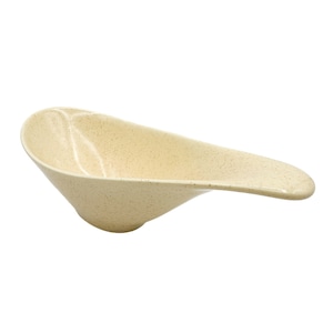 May include: A speckled beige ceramic serving dish with a long, curved handle. The dish is designed to hold sauces or dips.