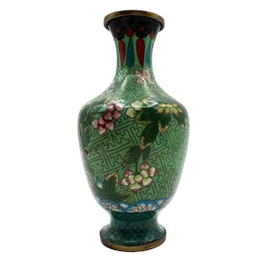 May include: A green and white cloisonné vase with floral and geometric patterns. The vase has a narrow neck and a wide base.