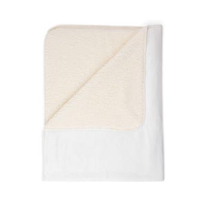 May include: A white blanket with a cream-colored, plush sherpa lining. The blanket is folded over, revealing the soft, textured interior. The exterior is smooth and white, creating a cozy and inviting aesthetic.