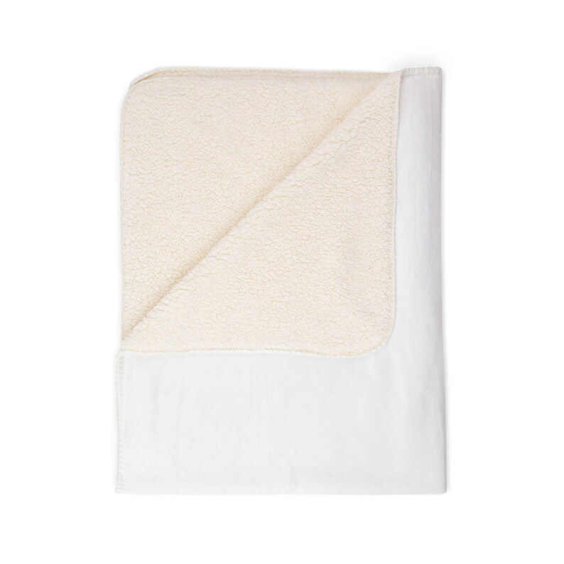 May include: A white blanket with a cream-colored, plush sherpa lining. The blanket is folded over, revealing the soft, textured interior. The exterior is smooth and white, creating a cozy and inviting aesthetic.