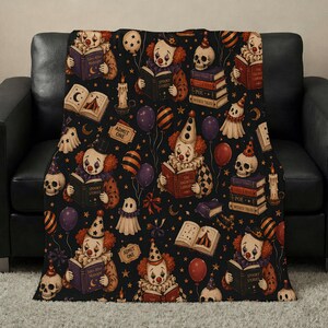 Vintage Halloween clown reading blanket with red‑haired clowns holding spooky books, skulls, candles, tickets, ghosts, stars, and balloons on a black background; available in ultra‑plush sherpa or smooth velveteen styles and in 50x60 and 60x80 inch sizes