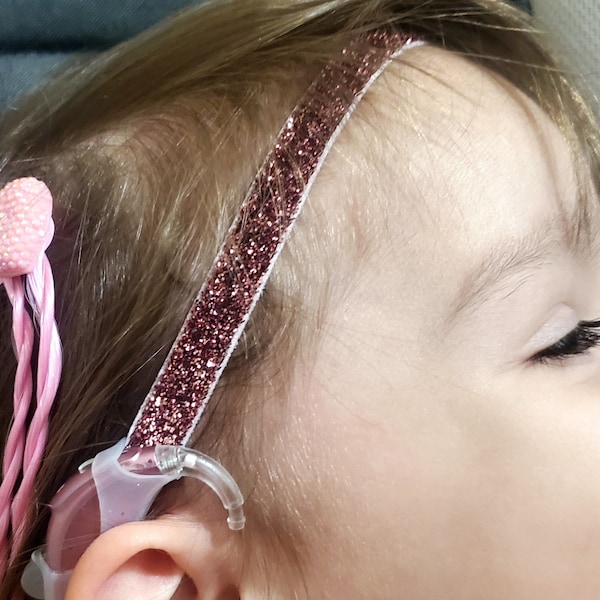 Pink Glittery hearing aid retainer,  3/4 inch width with silicone sleeves. Or cochlear headband with loop material sleeves