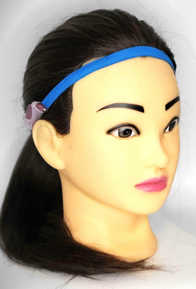 May include: A blue headband with a purple earpiece attached to it.