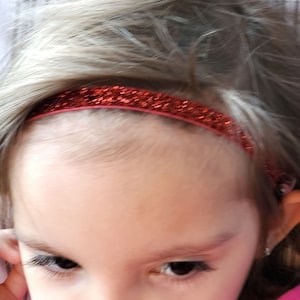 Orange glitter hearing aid or cochlear headband add some sparkle to your wardrobe .