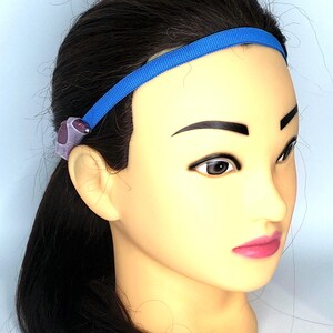 May include: A blue headband with a purple and gray bead accent.