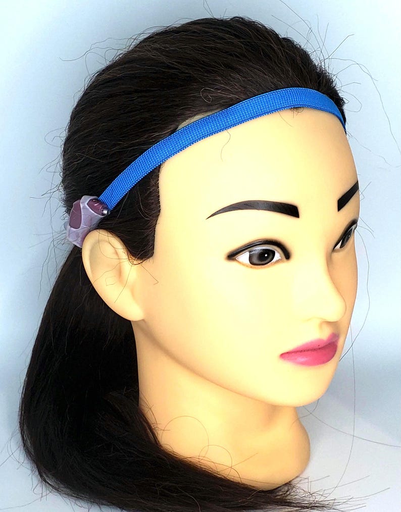 May include: A blue headband with a purple and gray bead accent.