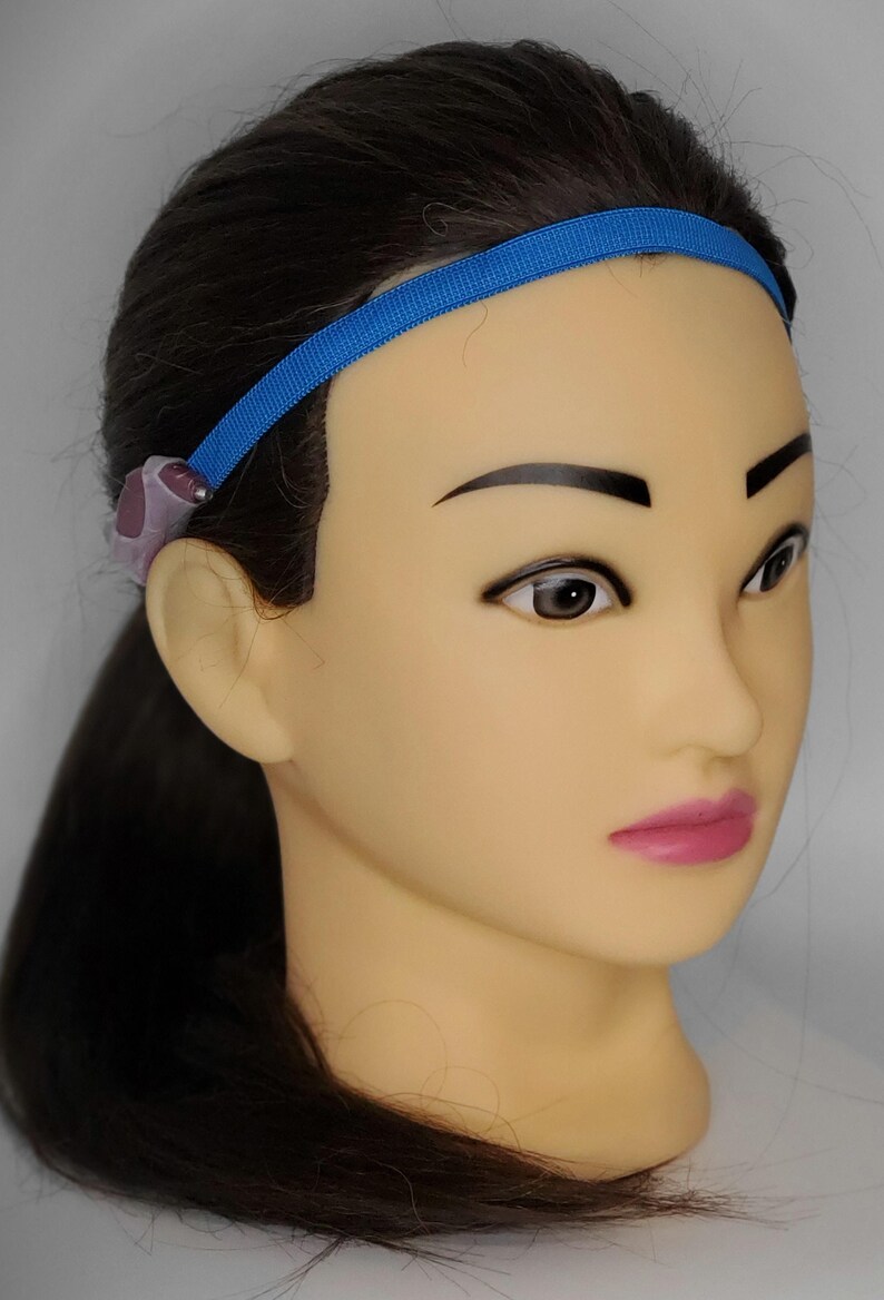 May include: A blue headband with a purple and gray earpiece attached to it.