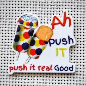 May include: White sticker with two cartoon popsicles, one orange and one with red, yellow, and blue polka dots. The text reads "Ah Push It push it real good".