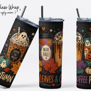 May include: Three tall cylindrical tumblers with clear lids and metal straws, featuring a black background with colorful autumn-themed illustrations of coffee cups, ghosts, pumpkins, and maple leaves, with text reading Sippin on Magic, Hello Fall, Leaves & Coffee Please.