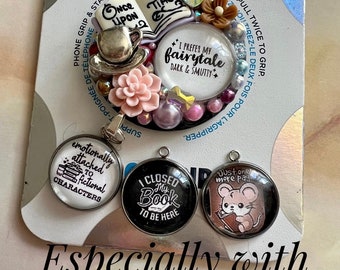 May include: A set of four charm pendants featuring book-themed designs. The charms are round and have a glass top with a black background. The text on the charms reads "Once Upon A Time", "I Prefer My Fairytale Dark & Smutty", "Emotionally Attached To Fictional Characters", "I Closed My Book To Be Here", and "Just One More Page". The charms are surrounded by a variety of decorative elements, including a book, a teacup, flowers, and beads.