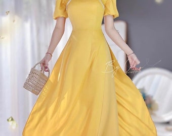 Modern short sleeves gold ao dai set