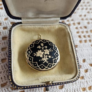 Antique Victorian gold locket back and front with black enamel and flowers