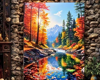 Könnte beinhalten: Gerahmtes Landschaftsgemälde mit einer Herbstszene, in der ein Fluss durch einen Wald fließt. Die Bäume zeigen leuchtend orange und gelbe Blätter, die sich im Wasser spiegeln. Berge sind im Hintergrund unter blauem Himmel zu sehen.