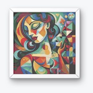 May include: Framed abstract artwork of a woman's portrait. The image uses geometric shapes and a vibrant colour palette of red, blue, green, and yellow. The woman's face is in profile, with closed eyes and red lips.