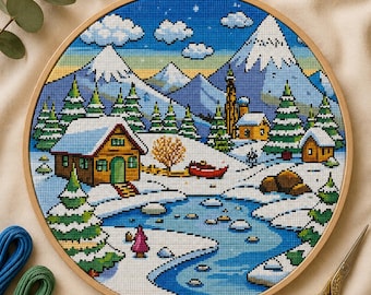 Op de afbeelding: Een ronde houten borduurring met een kruissteekpatroon van een winterlandschap. De afbeelding toont besneeuwde bergen, naaldbomen, twee kleine houten hutten, een bevroren blauwe rivier en een figuur in een roze jas.