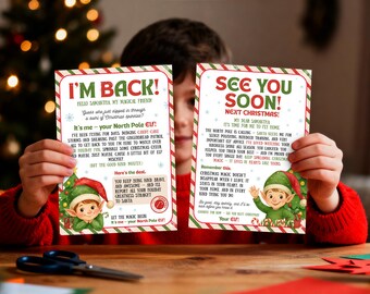 May include: Two Christmas cards are held up, featuring festive designs with elves and holiday greetings. The cards have red and green borders, with text that reads "I'm Back!" and "See You Soon! Next Christmas!" The cards are held by a person.