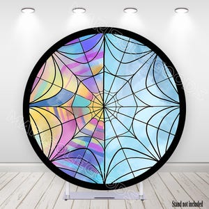 May include: A round backdrop with a black border, featuring a spiderweb design. The web is divided into quadrants with watercolor-style backgrounds in shades of blue, yellow, and purple. The words "Stand not included" are at the bottom.