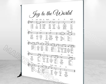 May include: A black and white sheet music backdrop with the words "Joy to the World" in a decorative font. The sheet music includes the lyrics and musical notes for the Christmas carol.