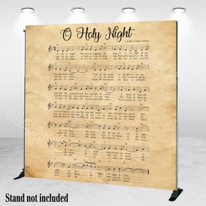 May include: A large backdrop featuring sheet music for "O Holy Night" with the title in elegant script. The background has a vintage, aged paper appearance. The text "Stand not included" is at the bottom.