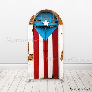 May include: A wooden door painted with the Puerto Rican flag design. The door features red and white stripes with a blue triangle and white star. The door is set in a white arched frame with a blue shutter.