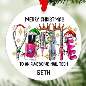 May include: Circular Christmas decoration with nail technician-themed illustrations. Includes nail tools, a pink nail polish bottle, and the text "Merry Christmas To An Awesome Nail Tech BETH". The ornament has a red ribbon.