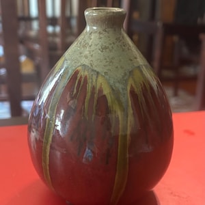 Nice brown and green drip glaze blown bud vase.