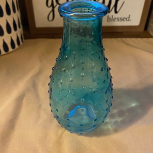 Set of 2 hobnail clear glass bud vase and hobnail blue glass bud vase.