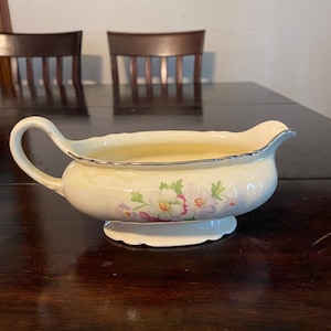 Vintage Virginia Rose pattern gravy boat serving dish with gold rim.